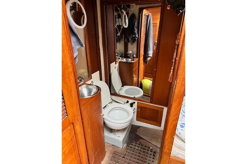 Slide: The Image of 1985 Robert Clark Ketch yacht bathroom with wooden cabinetry and compact fixtures. - 46