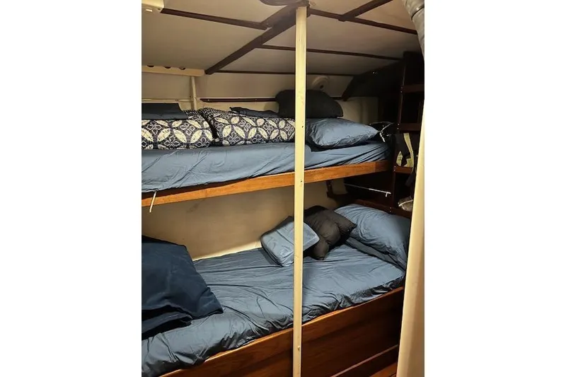 Slide: The Image of Bunk beds in 1985 Robert Clark Ketch sailboat cabin with blue bedding. - 48