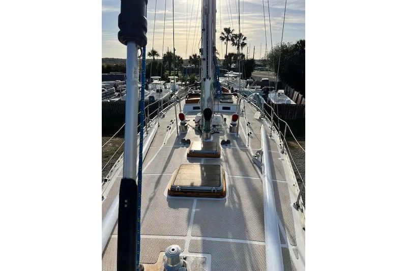 Slide: The Image of 1985 Robert Clark Ketch sailboat deck view with masts and rigging under a sunny sky. - 5