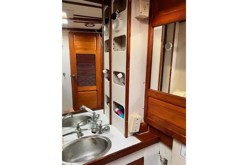 Slide: The Image of 1985 Robert Clark Ketch bathroom with wooden cabinetry and dual sinks. - 54