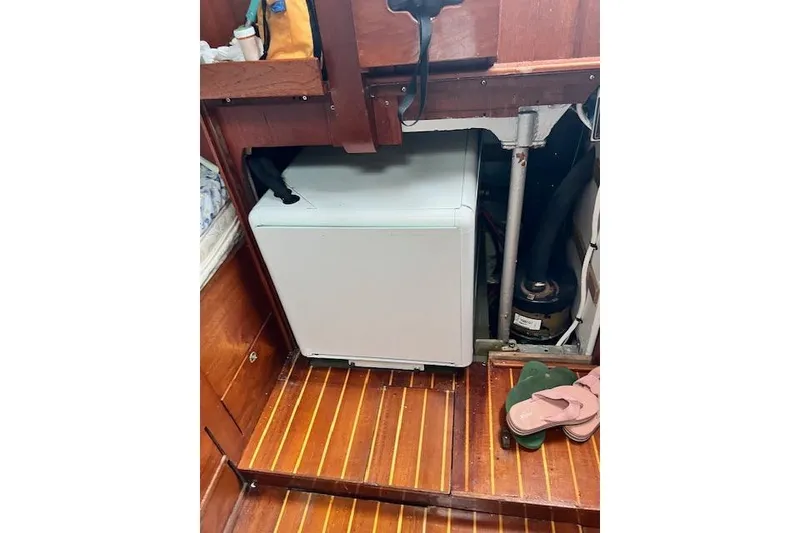 Slide: The Image of Compact washing machine in 1985 Robert Clark Ketch interior with wooden flooring. - 64