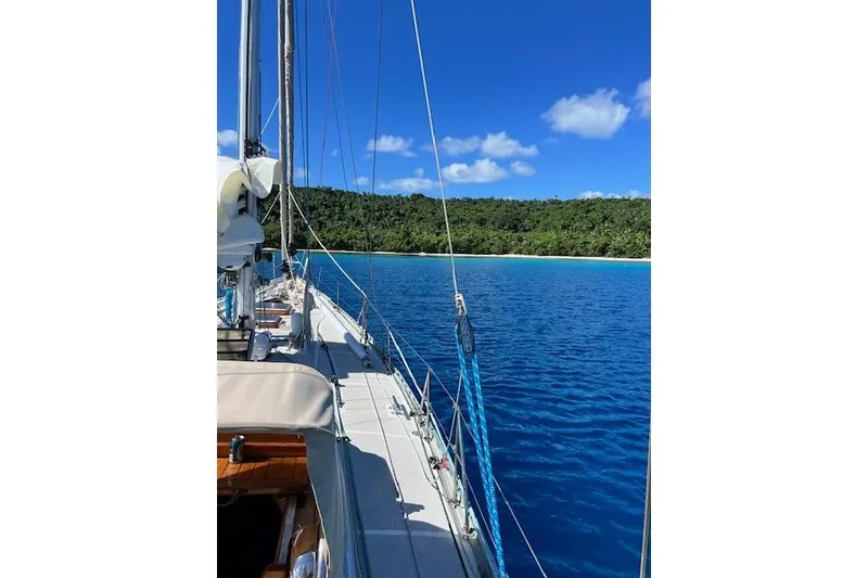 Slide: The Image of Sailing on a 1985 Robert Clark Ketch near a tropical island with clear blue waters. - 8