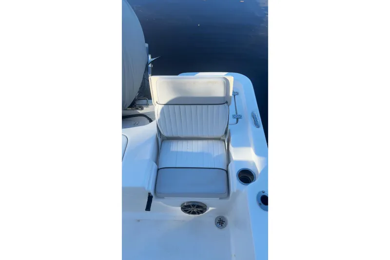 Slide: The Image of 2019 Sea Fox 200 Viper boat seat with storage, white upholstery, and cup holders. - 11