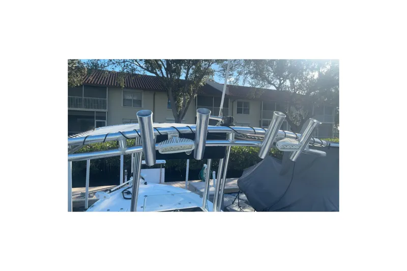 Slide: The Image of 2019 Sea Fox 200 Viper boat with rod holders, docked near residential buildings. - 19