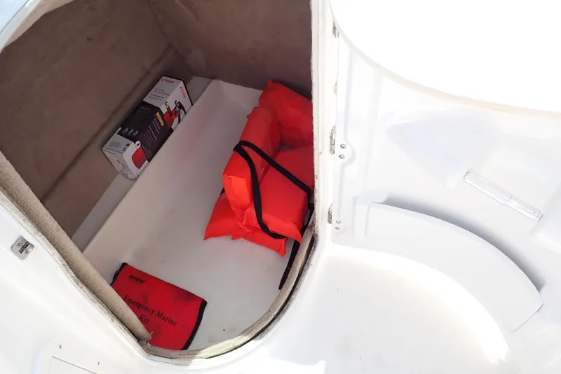 Slide: The Image of Storage compartment of 2021 NauticStar 223 DC boat with life jackets and safety equipment. - 11