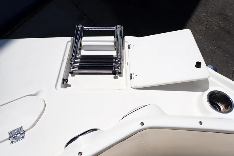 Slide: The Image of 2021 NauticStar 223 DC boat with folded ladder and storage compartment. - 13