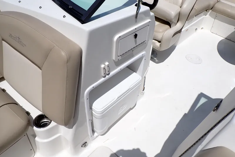 Slide: The Image of 2021 NauticStar 223 DC boat interior with beige seating and storage compartment. - 14