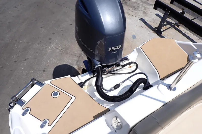 Slide: The Image of 2021 NauticStar 223 DC boat with Yamaha 150 engine, rear deck view. - 15