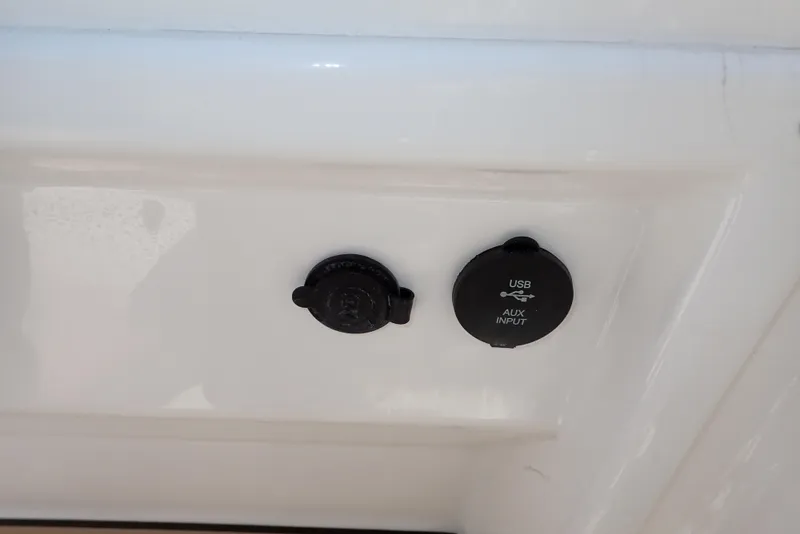 Slide: The Image of USB and auxiliary input ports on a 2021 NauticStar 223 DC boat. - 20