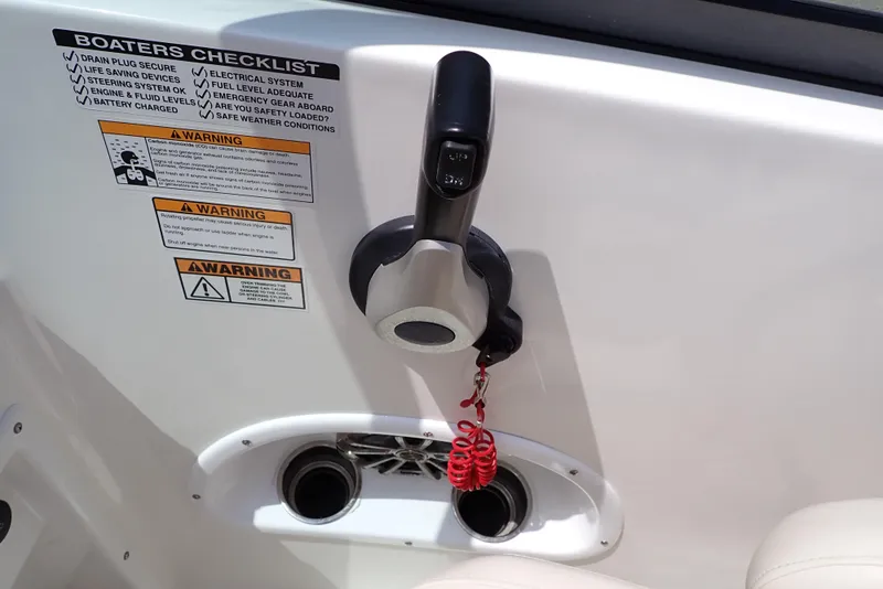 Slide: The Image of 2021 NauticStar 223 DC boat control panel with safety checklist and warning labels. - 21