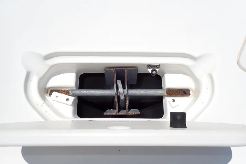Slide: The Image of Anchor compartment of 2021 NauticStar 223 DC boat, featuring a secure anchor holder. - 23