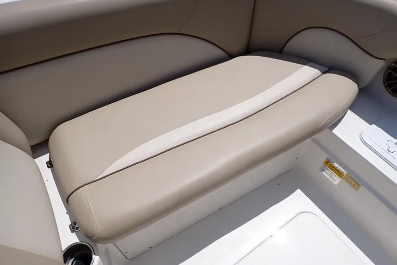 Slide: The Image of 2021 NauticStar 223 DC boat seat with beige upholstery and cup holder. - 25