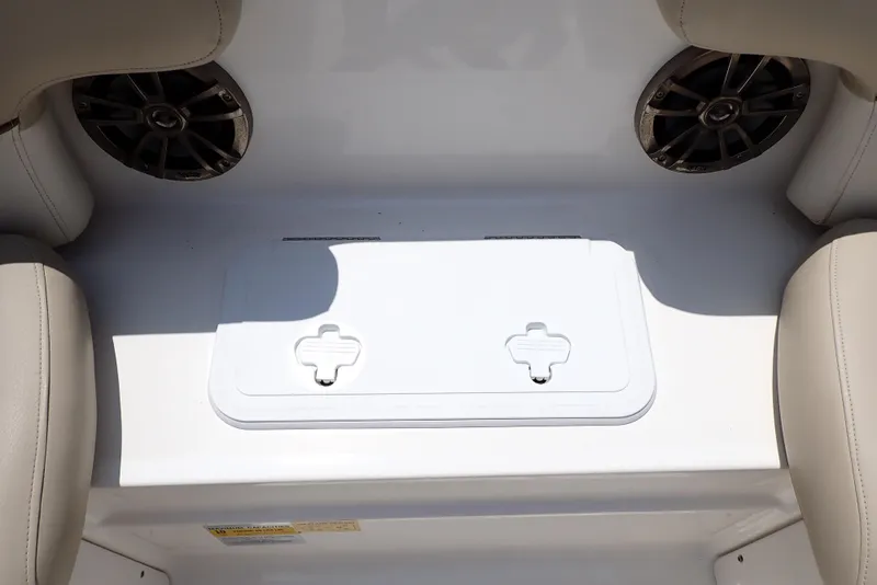 Slide: The Image of 2021 NauticStar 223 DC boat interior with storage compartment and speakers. - 27