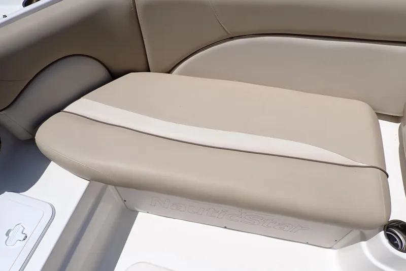 Slide: The Image of 2021 NauticStar 223 DC boat seat with beige upholstery and sleek design. - 28