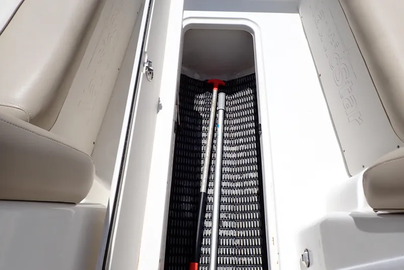 Slide: The Image of Storage compartment in 2021 NauticStar 223 DC boat with paddle inside. - 31