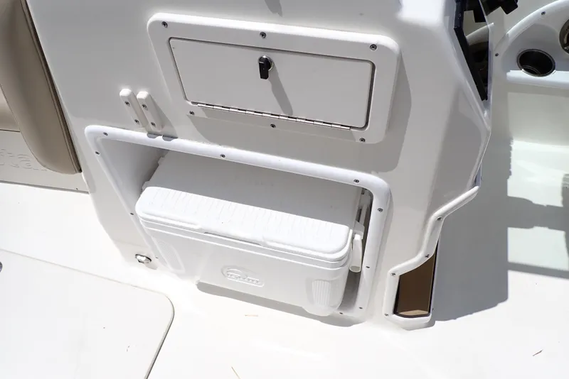 Slide: The Image of 2021 NauticStar 223 DC boat interior with storage compartment and cooler. - 32