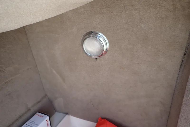 Slide: The Image of Interior of 2021 NauticStar 223 DC boat with light fixture and storage area. - 37