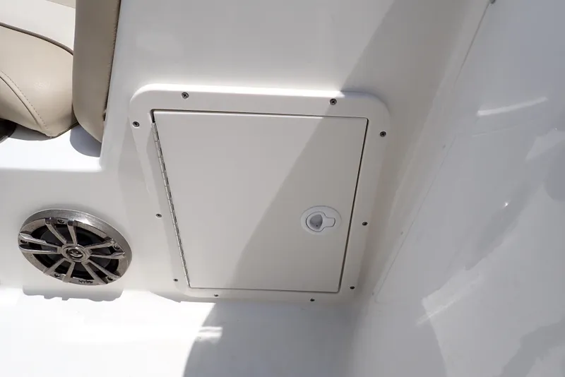 Slide: The Image of 2021 NauticStar 223 DC boat storage compartment and speaker detail. - 40