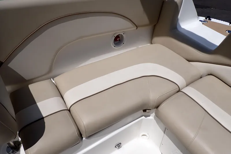 Slide: The Image of 2021 NauticStar 223 DC boat interior with beige and white cushioned seating. - 45