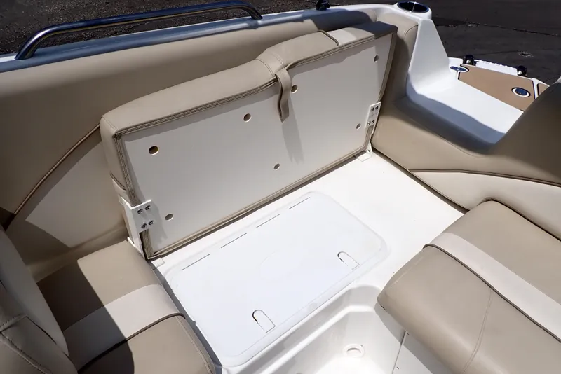Slide: The Image of 2021 NauticStar 223 DC boat interior with beige seating and storage compartment. - 46