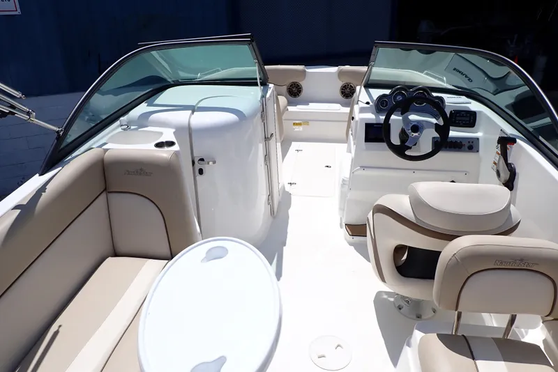 Slide: The Image of 2021 NauticStar 223 DC boat interior with seating and steering console. - 6