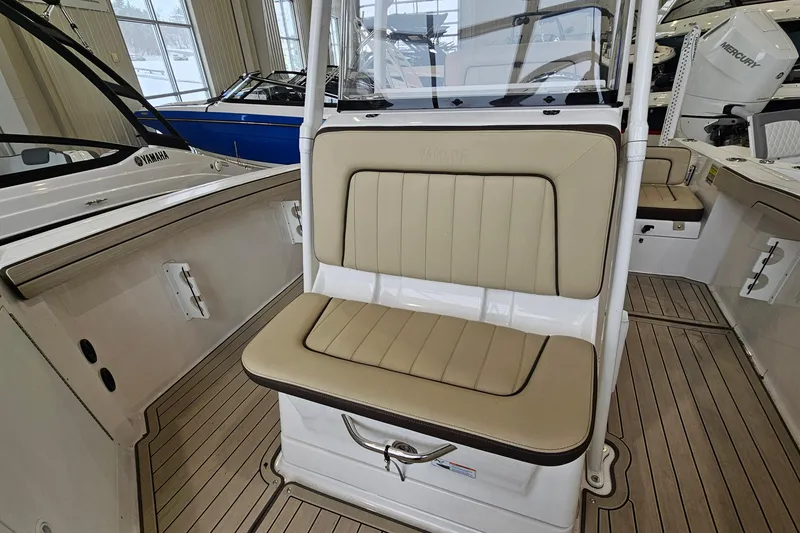 Slide: The Image of 2021 Yamaha Boats 210 FSH Sport interior with beige seating and sleek design. - 15