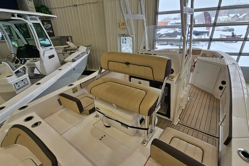 Slide: The Image of 2021 Yamaha Boats 210 FSH Sport interior with tan seating and modern design. - 5