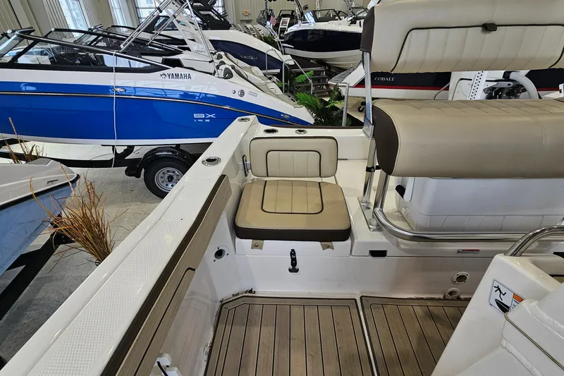Slide: The Image of 2021 Yamaha Boats 210 FSH Sport interior with seating and deck details. - 7