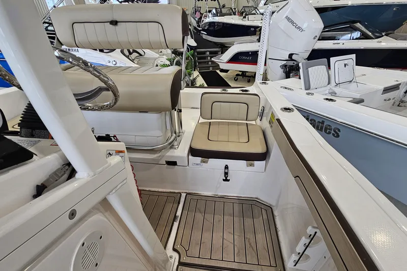 Slide: The Image of 2021 Yamaha Boats 210 FSH Sport interior with seating and steering wheel, showcasing modern design. - 8