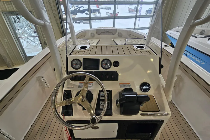 Slide: The Image of 2021 Yamaha Boats 210 FSH Sport dashboard with steering wheel and controls. - 9