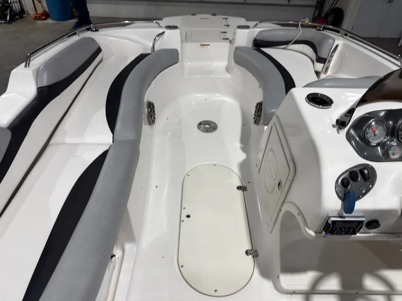 Slide: The Image of Interior of a 2014 Starcraft 2000 Limited boat with gray seating. - 19