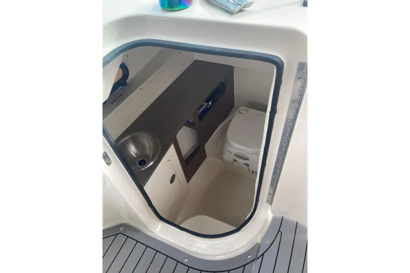 Slide: The Image of 2020 Sea Ray SDX 270 Outboard boat interior with sink and toilet. - 13