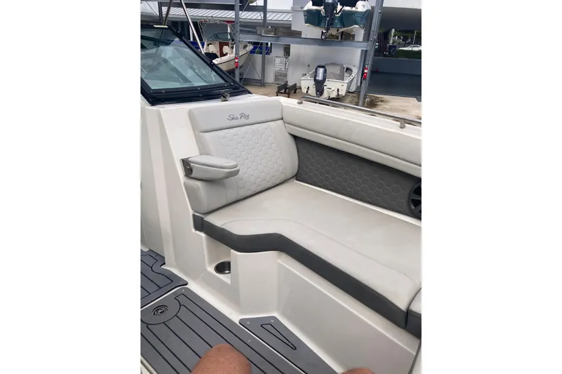 Slide: The Image of 2020 Sea Ray SDX 270 Outboard interior with cushioned seating and modern design. - 16