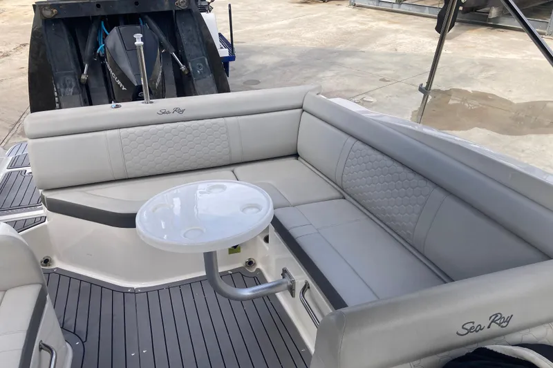 Slide: The Image of 2020 Sea Ray SDX 270 Outboard boat interior with gray seating and round table. - 26