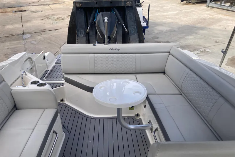 Slide: The Image of 2020 Sea Ray SDX 270 Outboard boat interior with gray seating and round table. - 28
