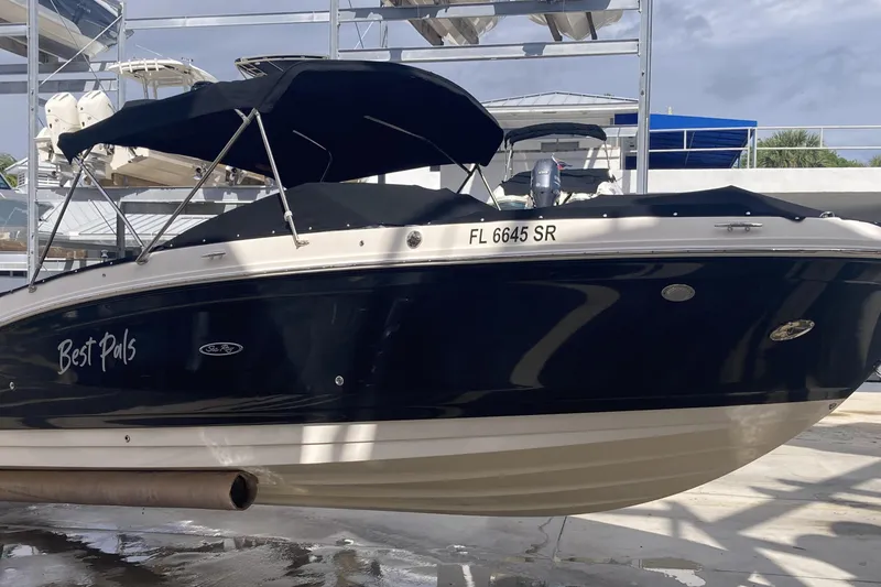 Slide: The Image of 2020 Sea Ray SDX 270 Outboard boat with black canopy, docked in marina. - 3