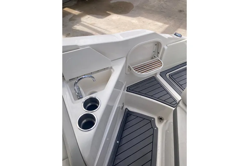Slide: The Image of 2020 Sea Ray SDX 270 Outboard interior with sink, cup holders, and non-slip flooring. - 31