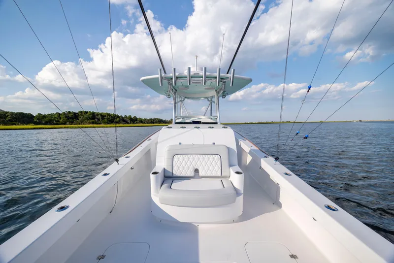 Slide: The Image of 2018 Tribute 37 boat interior with helm, ocean view, and clear sky. - 11