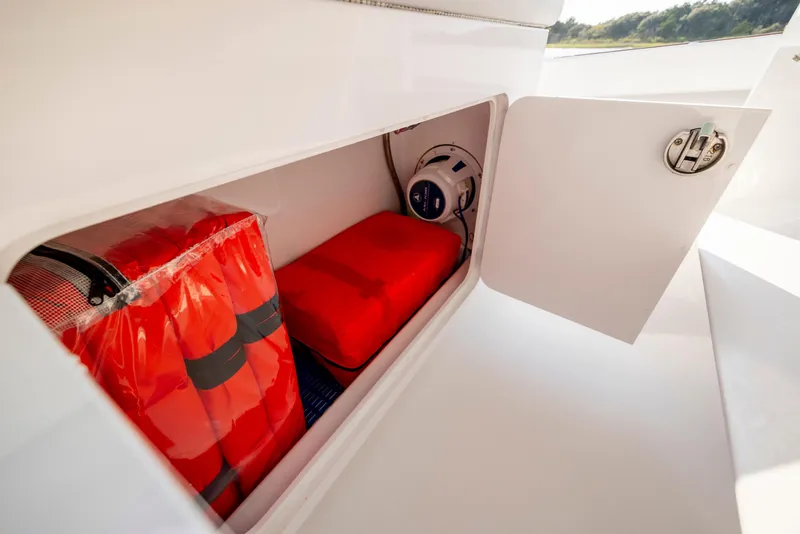 Slide: The Image of 2018 Tribute 37 boat interior with cushioned seating, ocean view, and clear sky. - 15