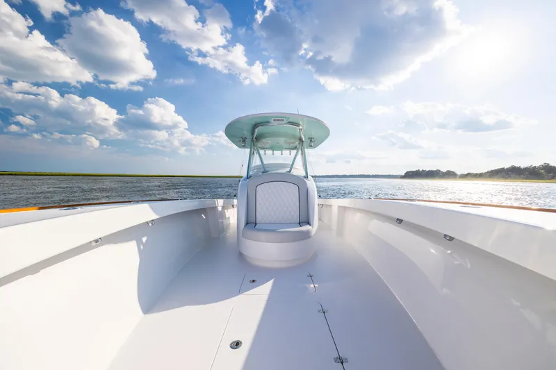 Slide: The Image of 2018 Tribute 37 boat with fishing rods on deck, calm water, and blue sky. - 17