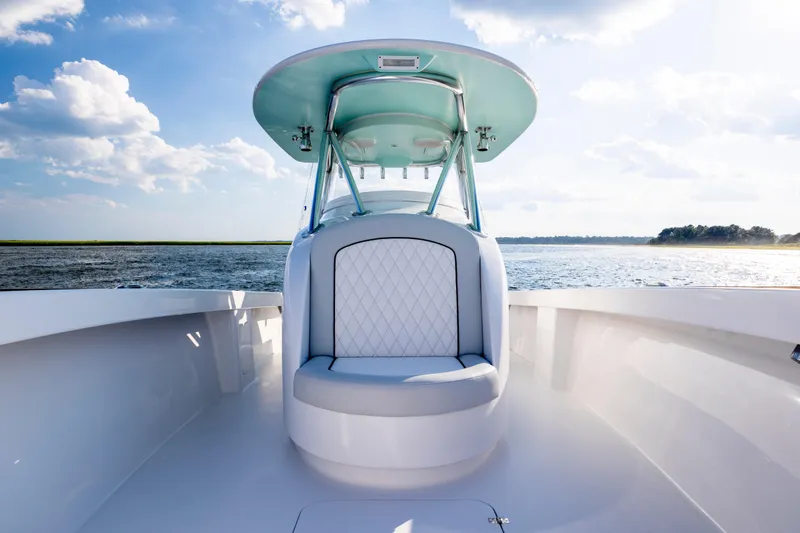 Slide: The Image of Luxurious 2018 Tribute 37 boat interior with elegant seating and polished steering wheel. - 18