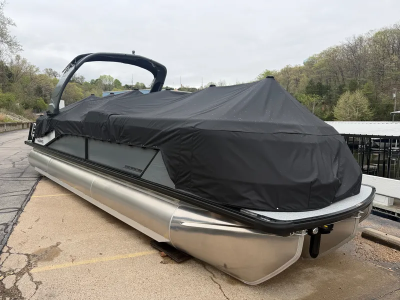 Slide: The Image of 2026 Harris Grand Mariner 270 pontoon boat covered on a parking lot. - 26