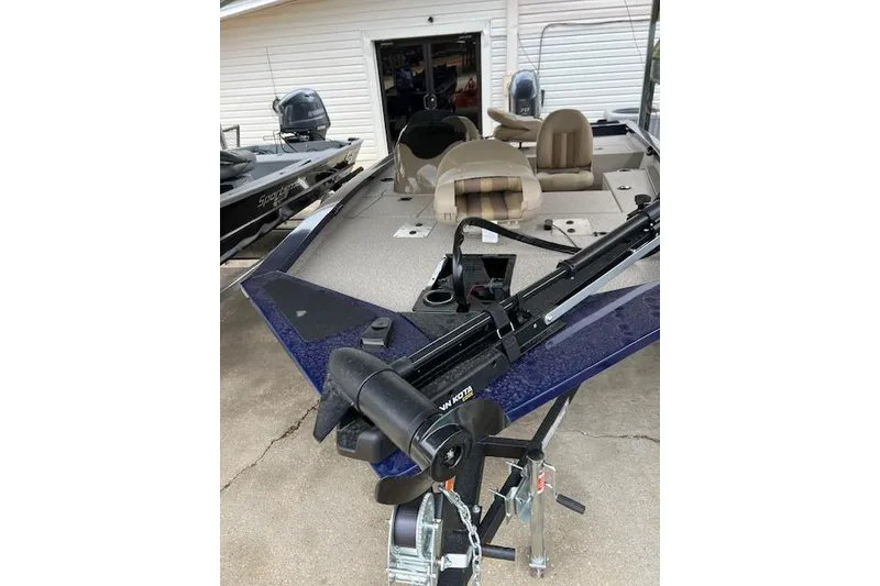 Slide: The Image of 2025 G3 Sportsman 1610 boat with trolling motor, parked in a garage. - 3