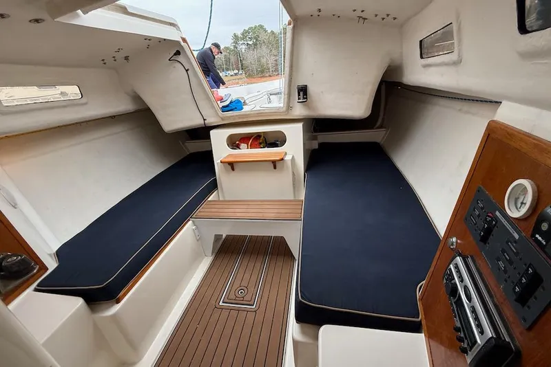 Slide: The Image of Interior of 2008 e Sailing Yachts e33, featuring cozy seating and wooden accents. - 13
