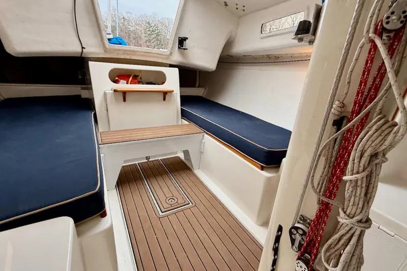 Slide: The Image of Interior of 2008 e Sailing Yachts e33 with wooden flooring and blue cushions. - 14