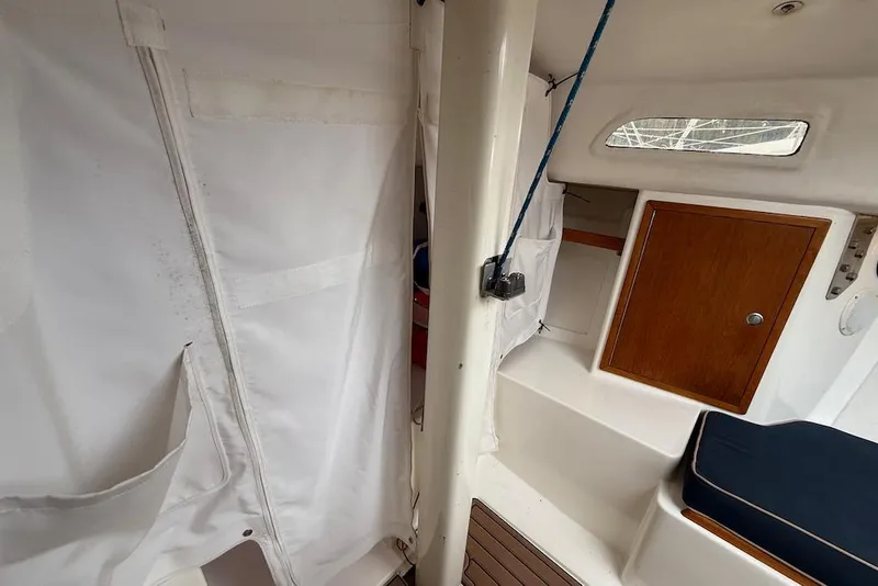Slide: The Image of Interior of 2008 e Sailing Yachts e33, featuring cabin with wooden accents and seating. - 16