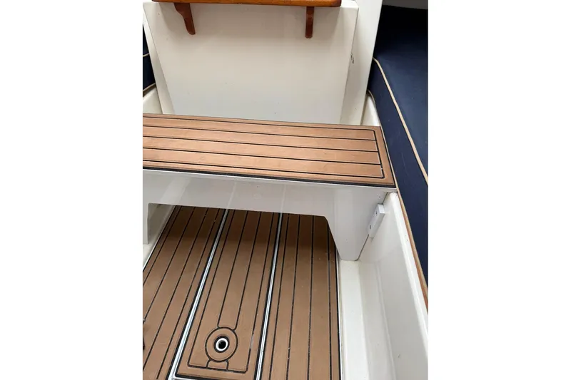 Slide: The Image of 2008 e Sailing Yachts e33 interior with wooden bench and flooring detail. - 17