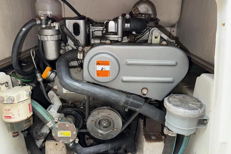 Slide: The Image of Engine compartment of a 2008 e Sailing Yachts e33, showcasing mechanical components and hoses. - 22