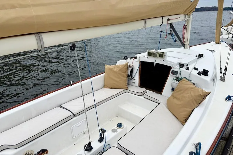 Slide: The Image of 2008 e Sailing Yachts e33 sailboat cockpit with beige cushions on calm water. - 4