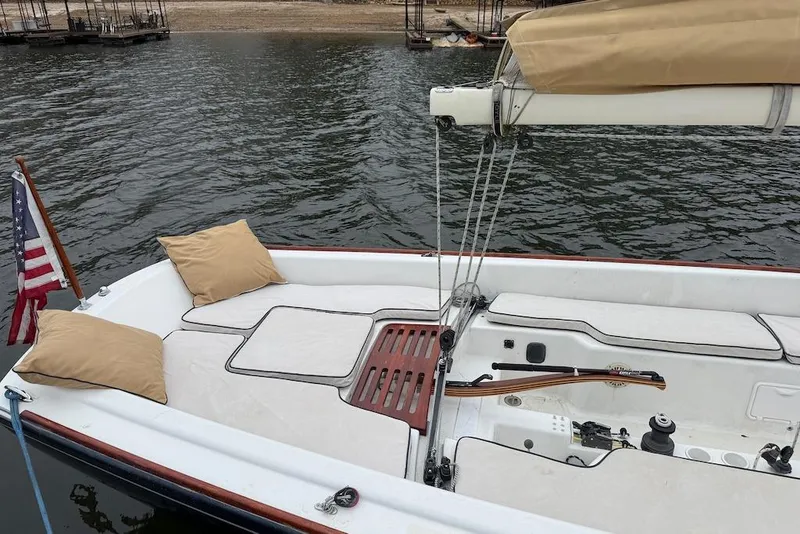 Slide: The Image of 2008 e Sailing Yachts e33 sailboat with cushions, docked by the water. - 6